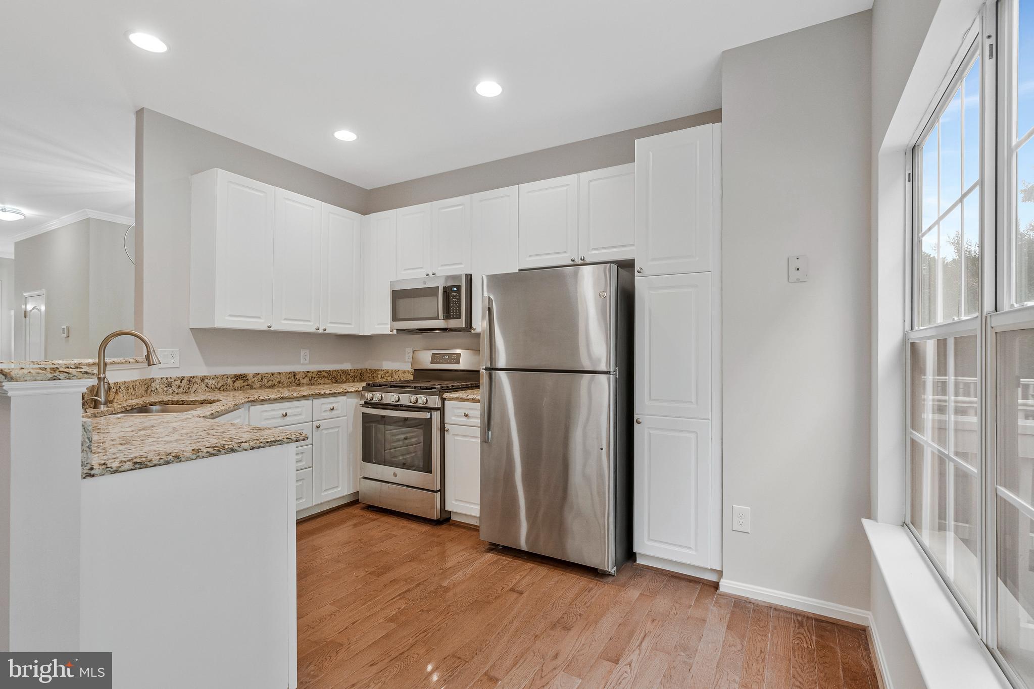 12033 Edgemere Circle Reston, VA 20190 - Photo 14 of 53 a kitchen with appliances a sink and a refrigerator