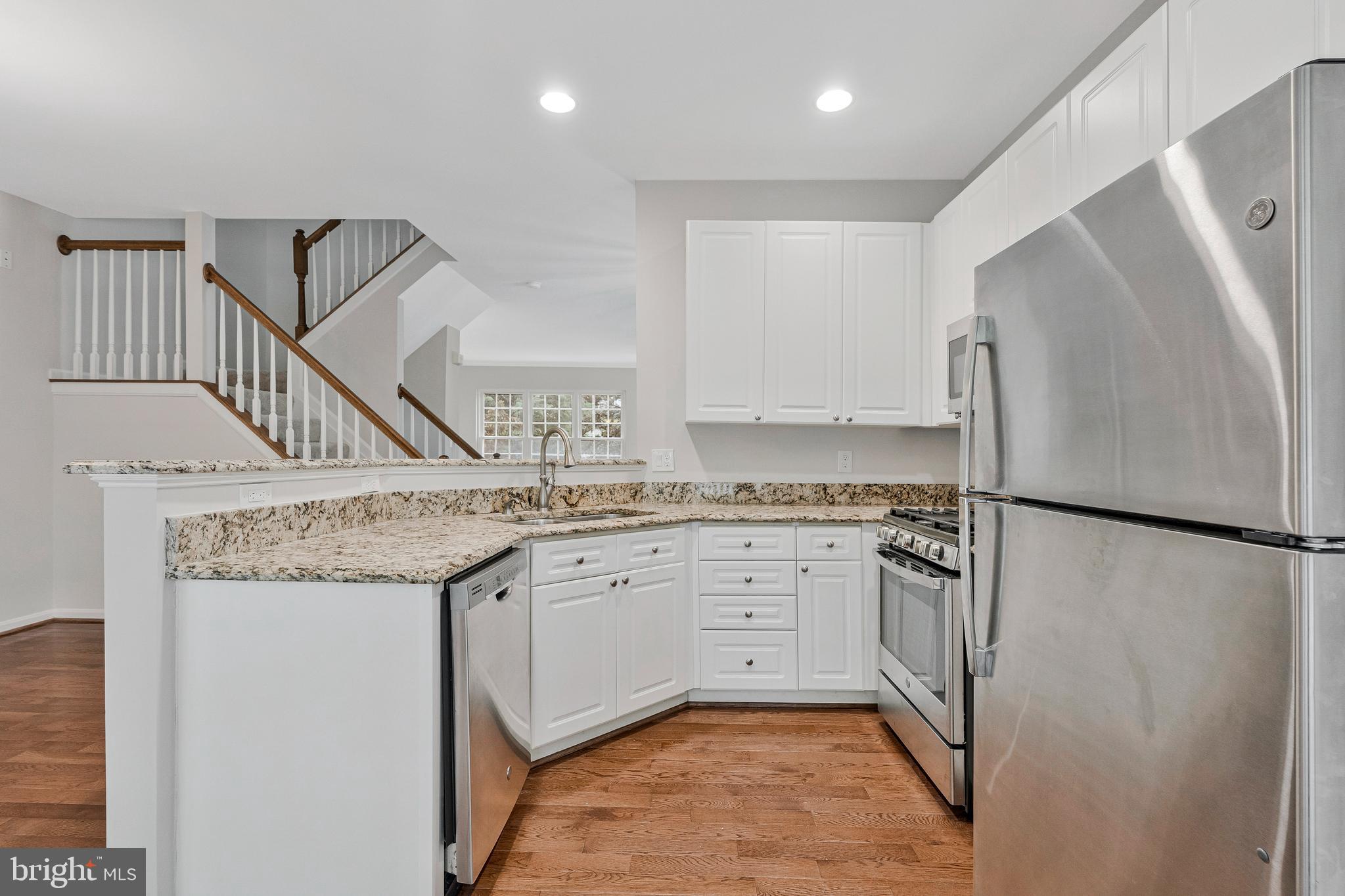 12033 Edgemere Circle Reston, VA 20190 - Photo 15 of 53 a kitchen with stainless steel appliances granite countertop a refrigerator a sink and a stove