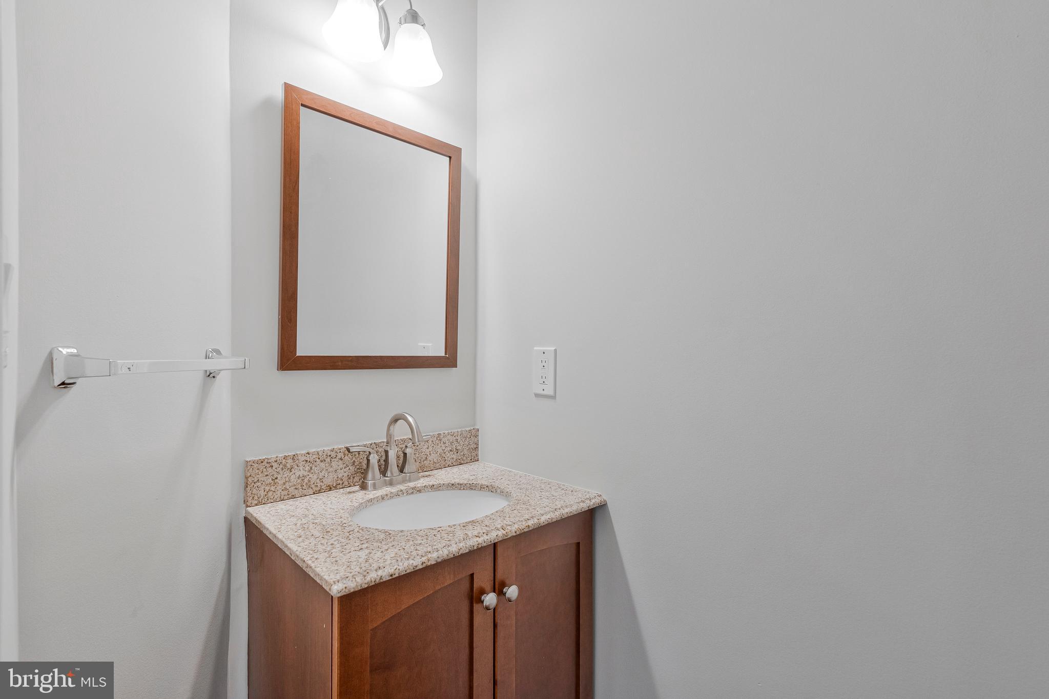 12033 Edgemere Circle Reston, VA 20190 - Photo 19 of 53 a bathroom with a granite countertop sink and a mirror