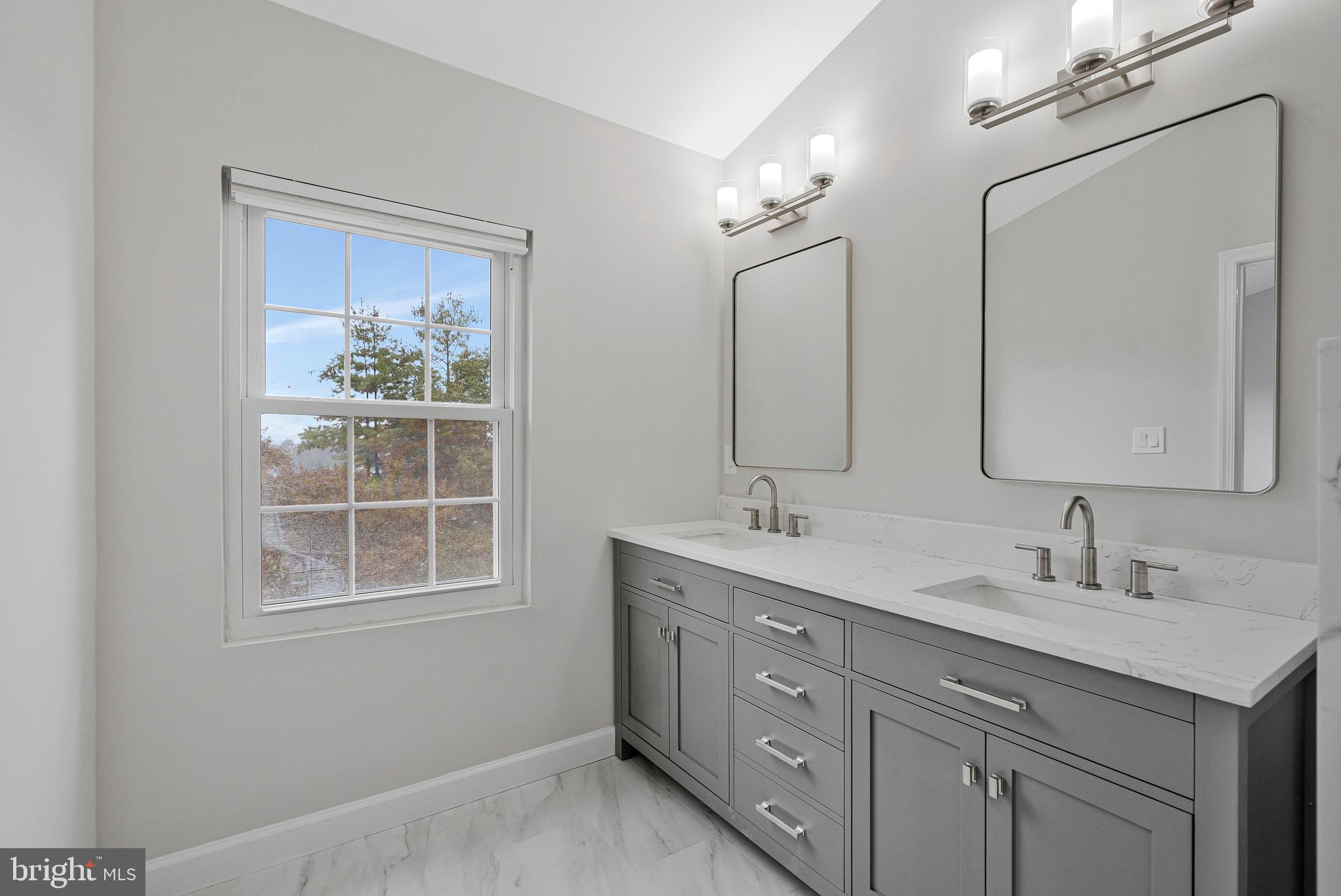 12033 Edgemere Circle Reston, VA 20190 - Photo 27 of 53 a bathroom with a double vanity sink and a mirror