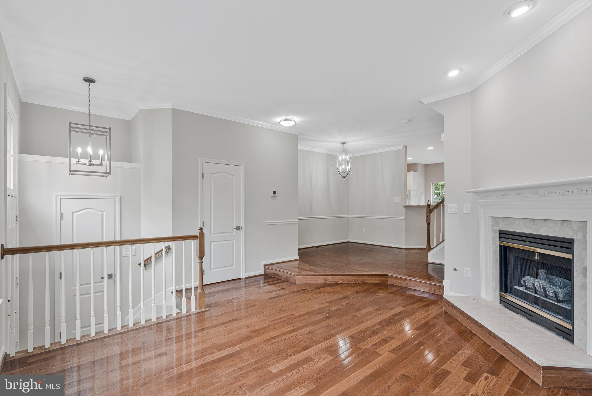 12033 Edgemere Circle Reston, VA 20190 - Photo 3 of 53 a view of empty room with wooden floor and fireplace