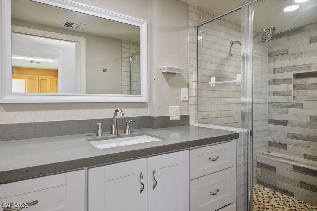 633 5th Street Boulder City, NV 89005 - Photo 17 of 29 Full bath with vanity, a shower stall, and a textured wall