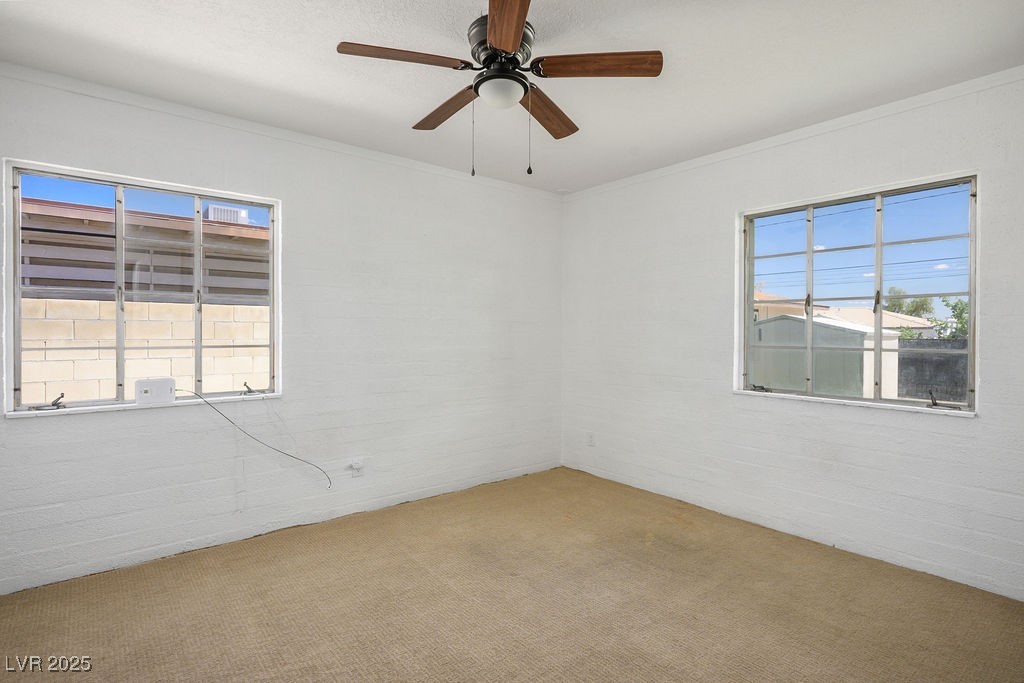 633 5th Street Boulder City, NV 89005 - Photo 20 of 29 Spare room featuring carpet floors, a ceiling fan, and crown molding