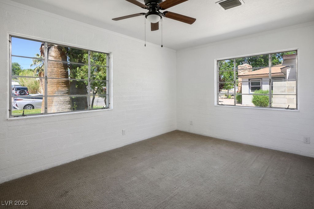 633 5th Street Boulder City, NV 89005 - Photo 21 of 29 Unfurnished room with carpet, crown molding, and a ceiling fan