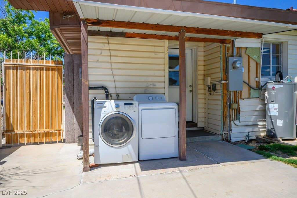633 5th Street Boulder City, NV 89005 - Photo 27 of 29 Laundry area featuring electric water heater and washing machine and dryer