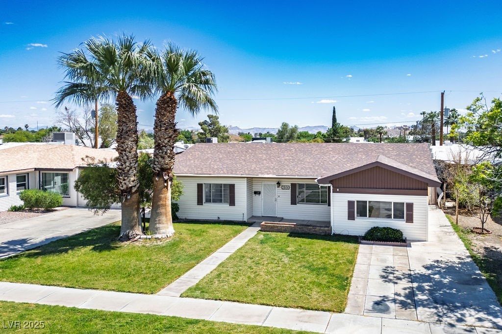 633 5th Street Boulder City, NV 89005 - Photo 3 of 29 Ranch-style home featuring a front yard, roof with shingles, and driveway