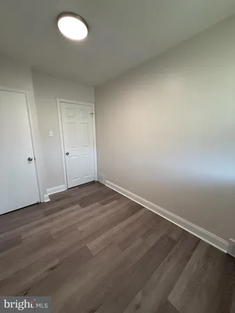 an empty room with wooden floor