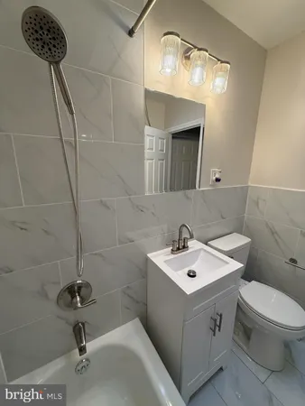 a bathroom with a sink a toilet and mirror
