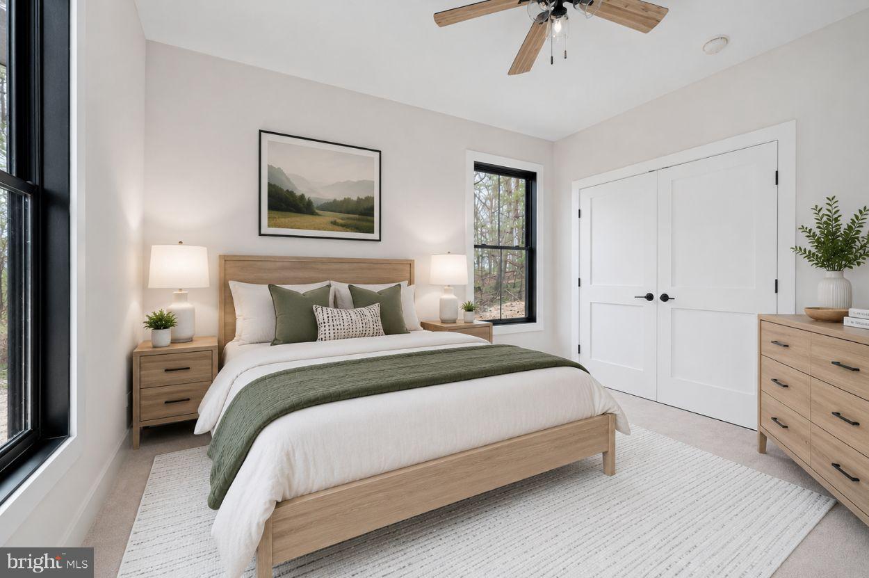 75 Sleepy Hollow Road Linden, VA 22642 - Photo 10 of 19 a spacious bedroom with a bed and a chandelier