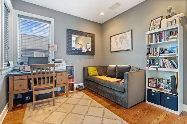 a living room with furniture and a book shelf