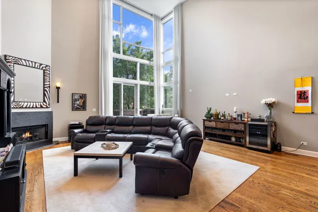 a living room with furniture a fireplace and a table