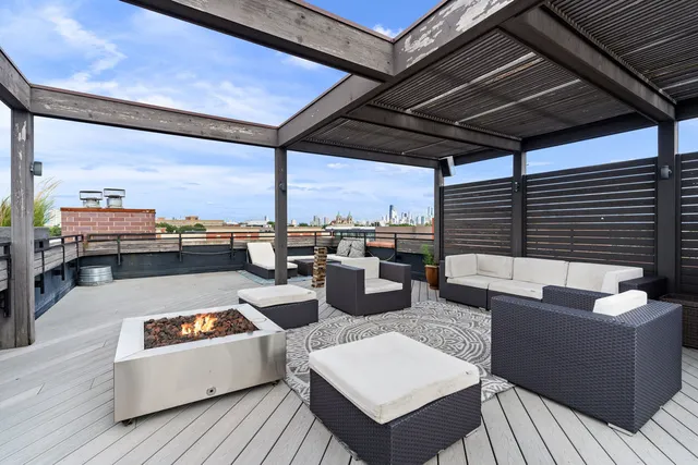 a living room with patio furniture and a fireplace