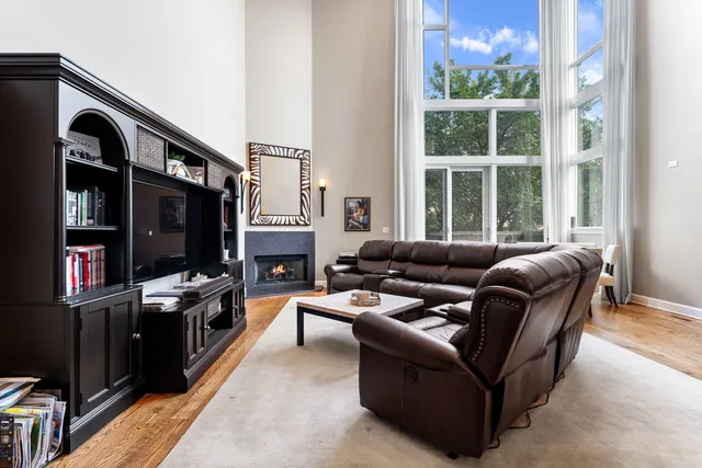 a living room with furniture a window and a flat screen tv