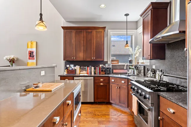 a kitchen with a sink a stove and cabinets