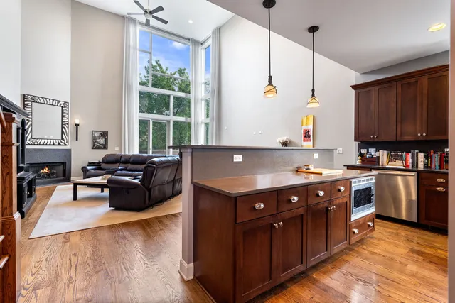 a kitchen with kitchen island granite countertop a sink appliances and cabinets
