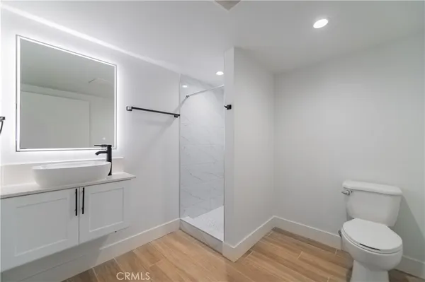 a bathroom with a sink a toilet and shower