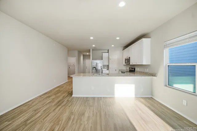 a view of kitchen with wooden floor and window