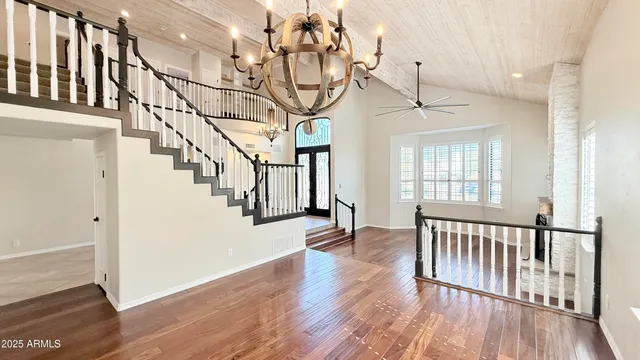a view of a livingroom with a ceiling fan and window