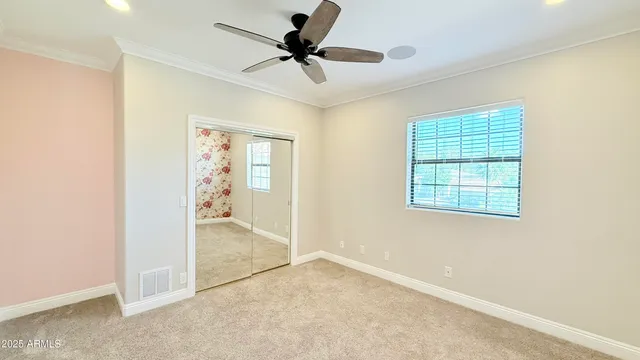 a bedroom with a large bed and a large window
