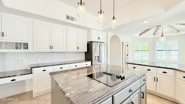 a view of an empty room with a fireplace and a window