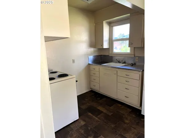 a kitchen with a cabinets and window