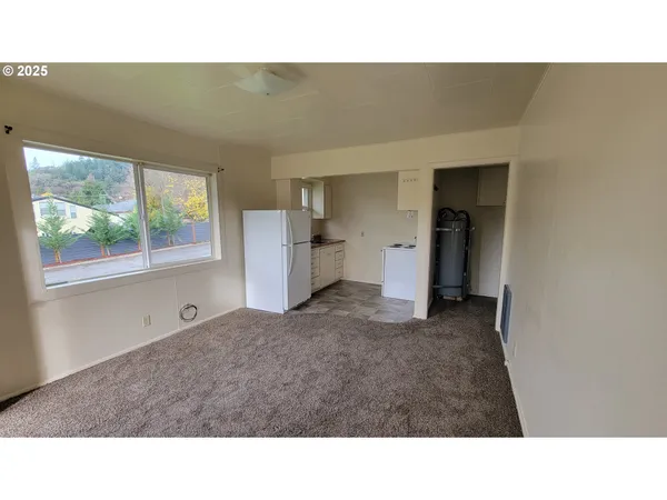 a kitchen with a refrigerator and window