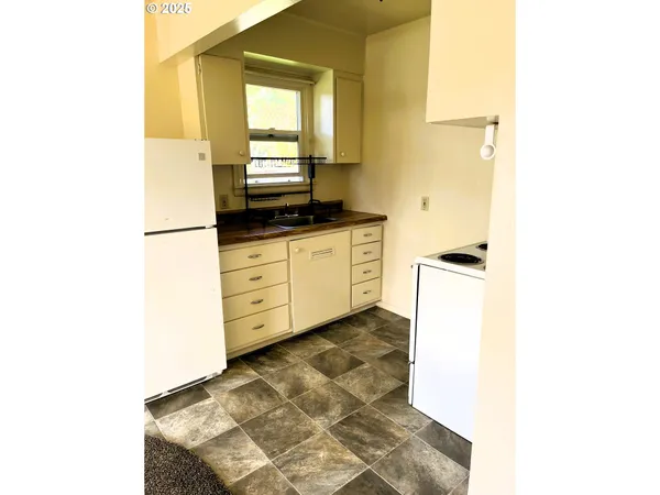 a kitchen with stainless steel appliances granite countertop a sink and a stove