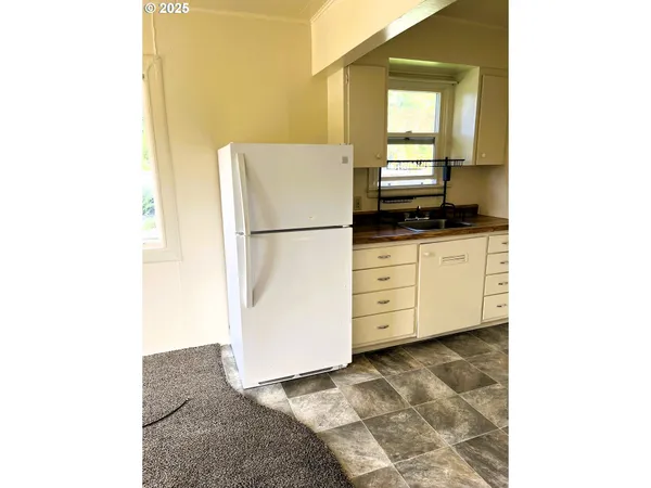 a kitchen with granite countertop cabinets and appliances