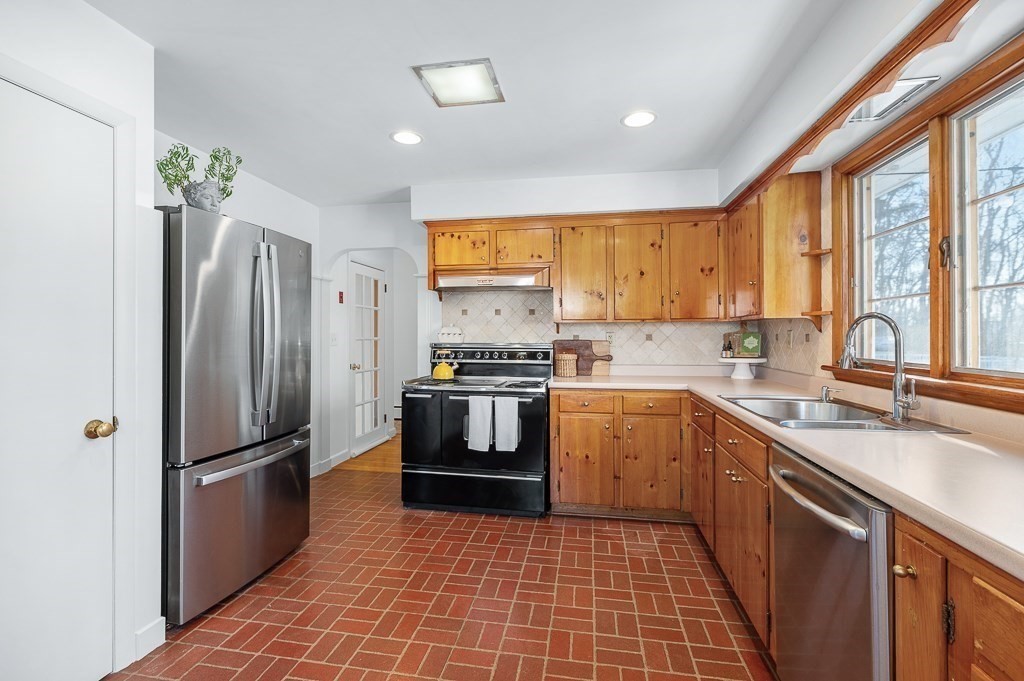 29 Old Ferry Road Haverhill, MA 01830 - Photo 12 of 42 a kitchen with granite countertop a refrigerator a sink a stove top oven and cabinets
