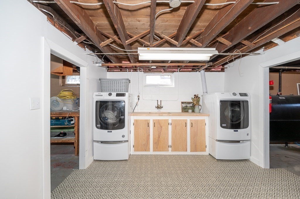 29 Old Ferry Road Haverhill, MA 01830 - Photo 27 of 42 a utility room with stainless steel appliances wooden floor and white cabinets
