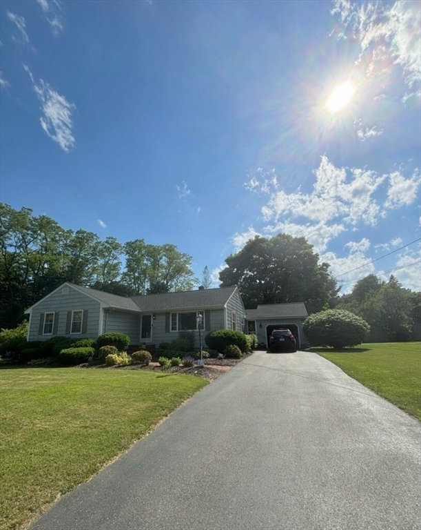 29 Old Ferry Road Haverhill, MA 01830 - Photo 3 of 42 a front view of a house with a yard and a garage