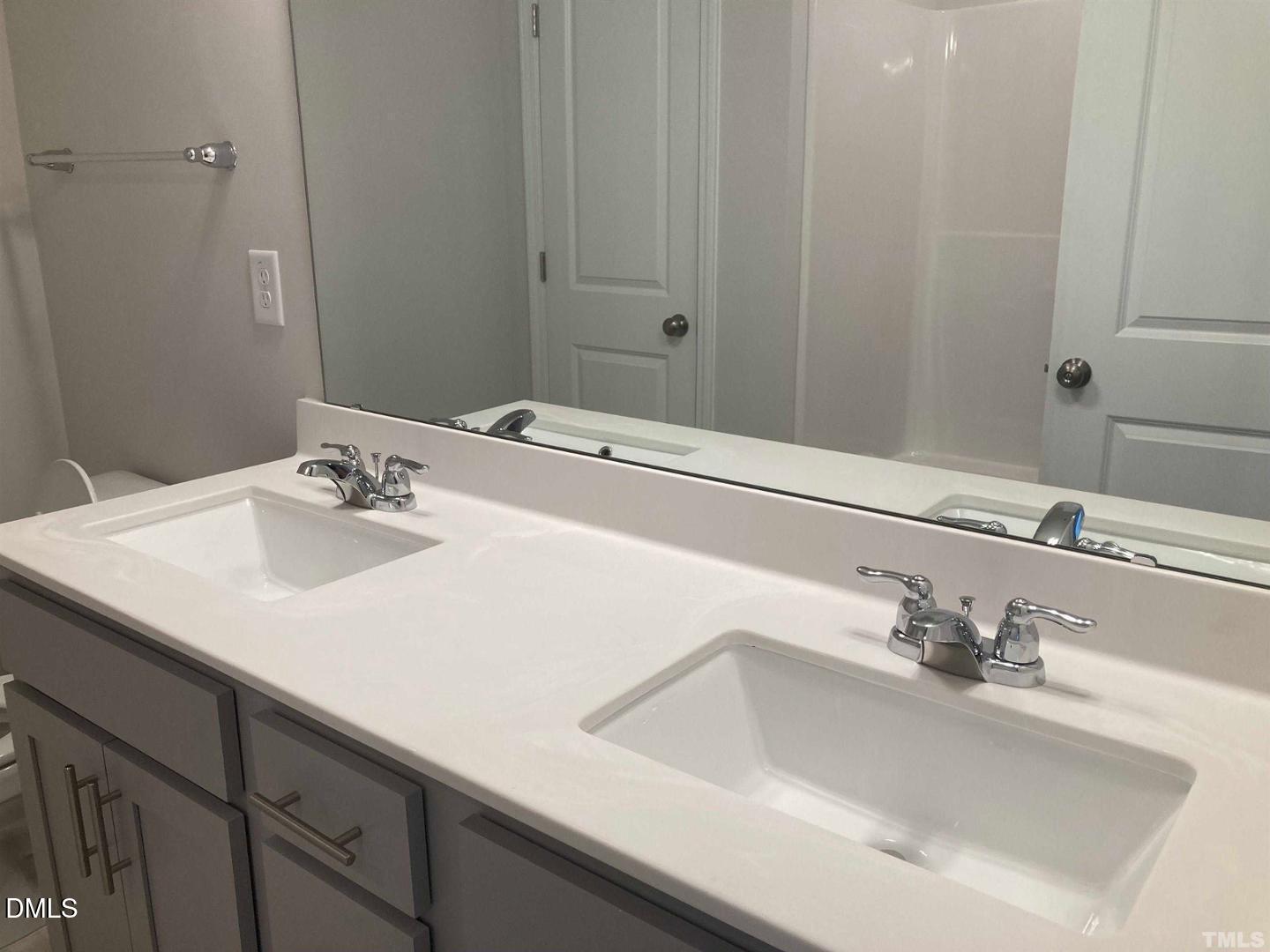 1823 Caen Street Raleigh, NC 27610 - Photo 8 of 13 a bathroom with a sink and a mirror