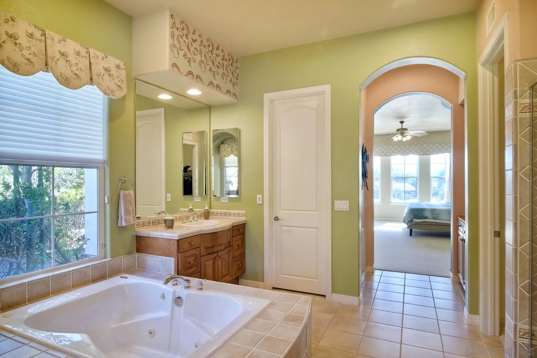 13675 Antelope Station Poway, CA 92064 - Photo 18 of 33 a en suite bathroom with a sink and mirror with bathtub