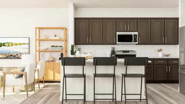 a kitchen with stainless steel appliances kitchen island granite countertop a stove a microwave a sink and cabinets