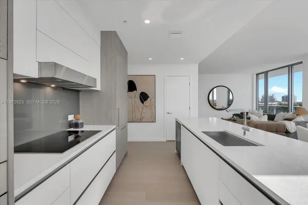 a large kitchen with a sink and cabinets