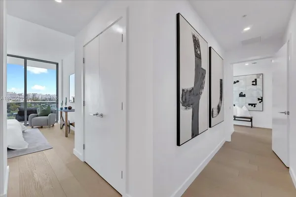 a view of a hallway with large windows and couches in a bathroom