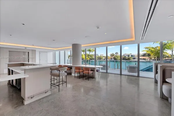 a living room with furniture and a floor to ceiling window