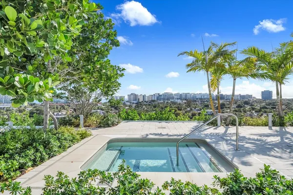 a view of yard with swimming pool outdoor seating and trees