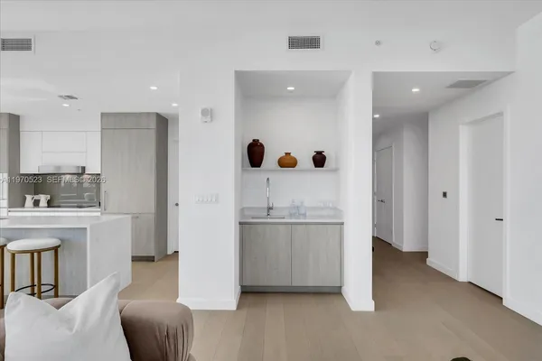 a kitchen with stainless steel appliances granite countertop a refrigerator and a stove top oven