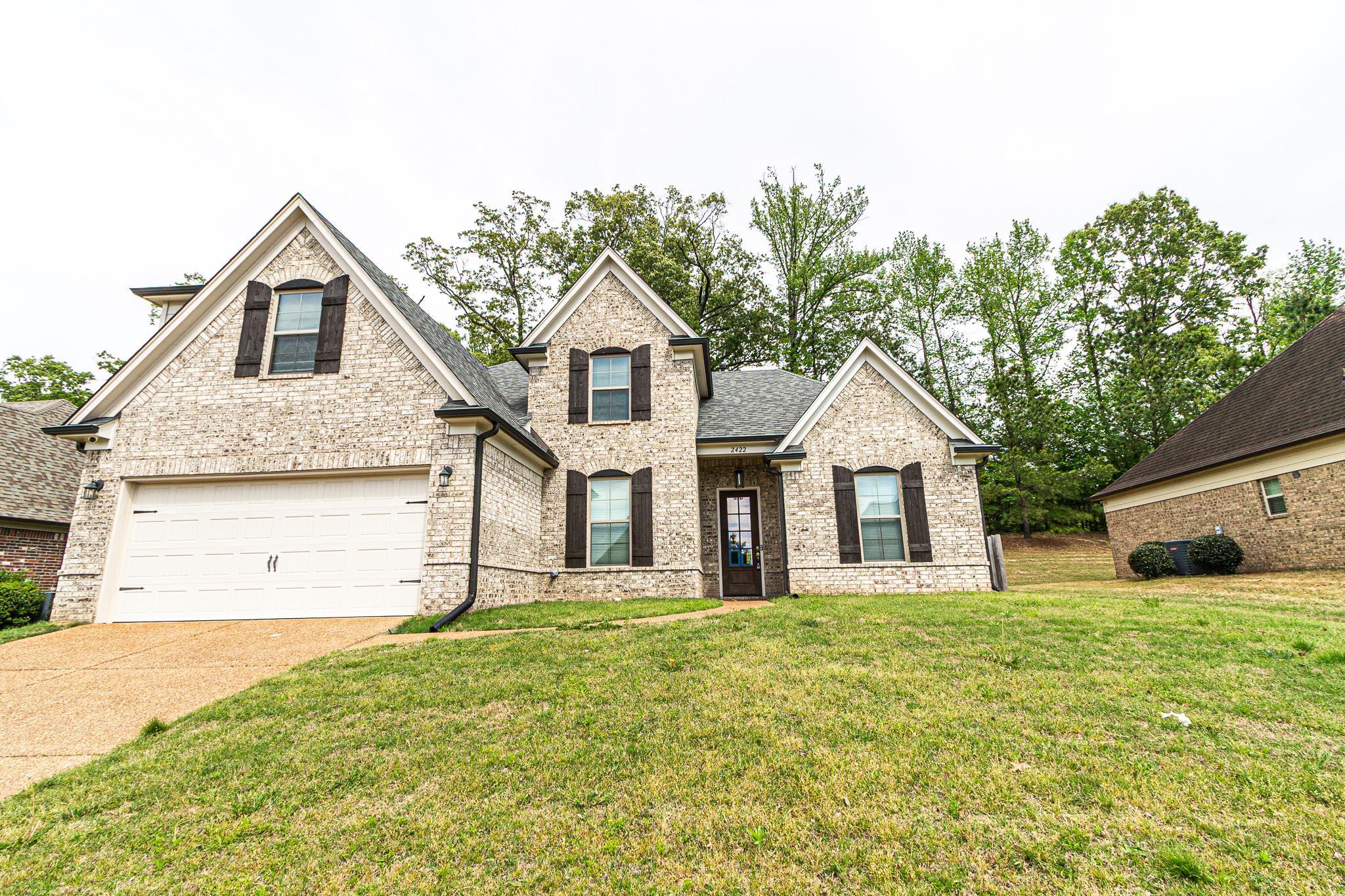 2422 Crimson Ridge Lane Cordova, TN 38016 - Photo 1 of 36 View of front facade featuring a front lawn, brick siding, driveway, and a shingled roof