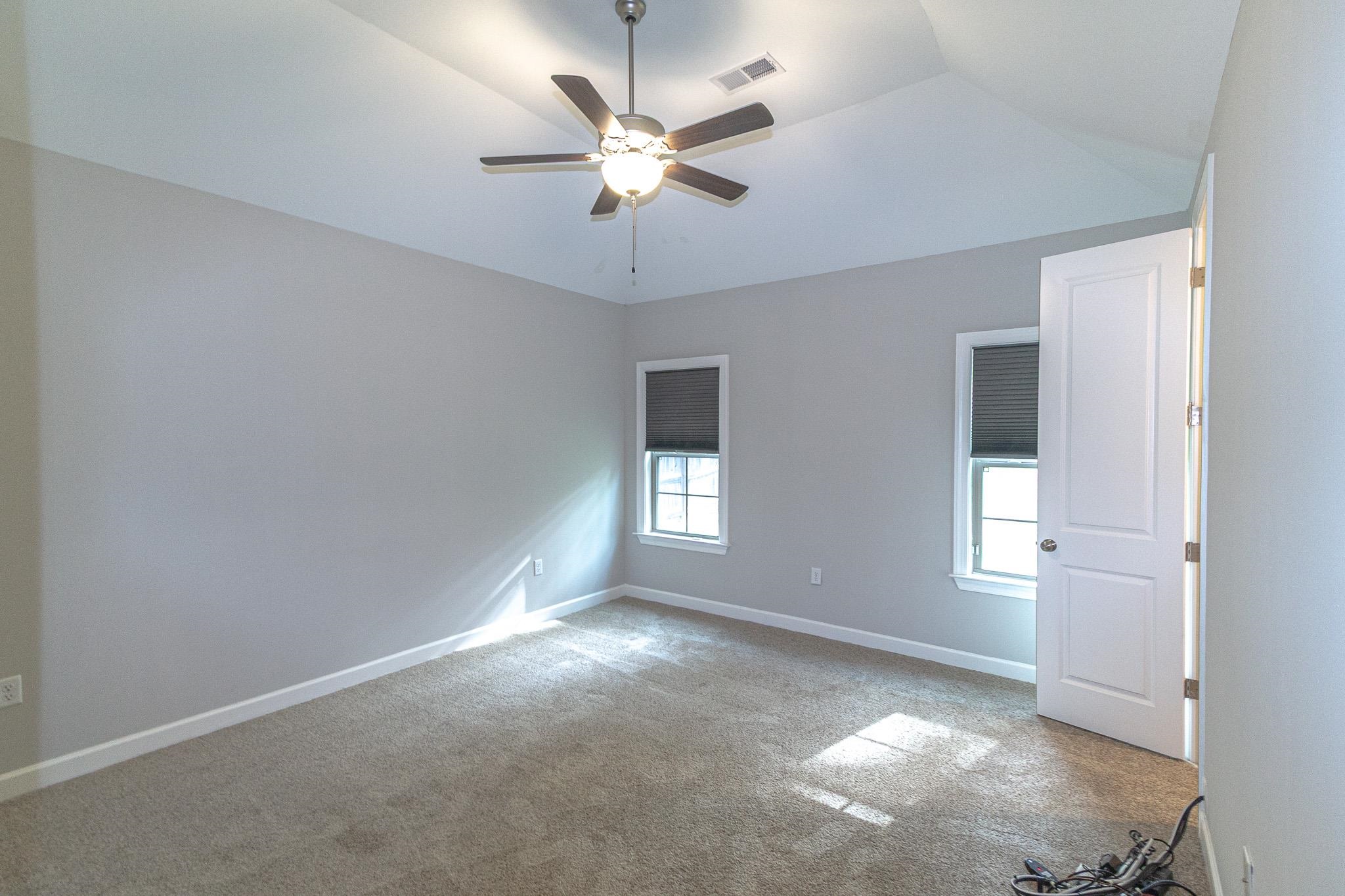 2422 Crimson Ridge Lane Cordova, TN 38016 - Photo 10 of 36 Unfurnished room with ceiling fan, vaulted ceiling, and light carpet
