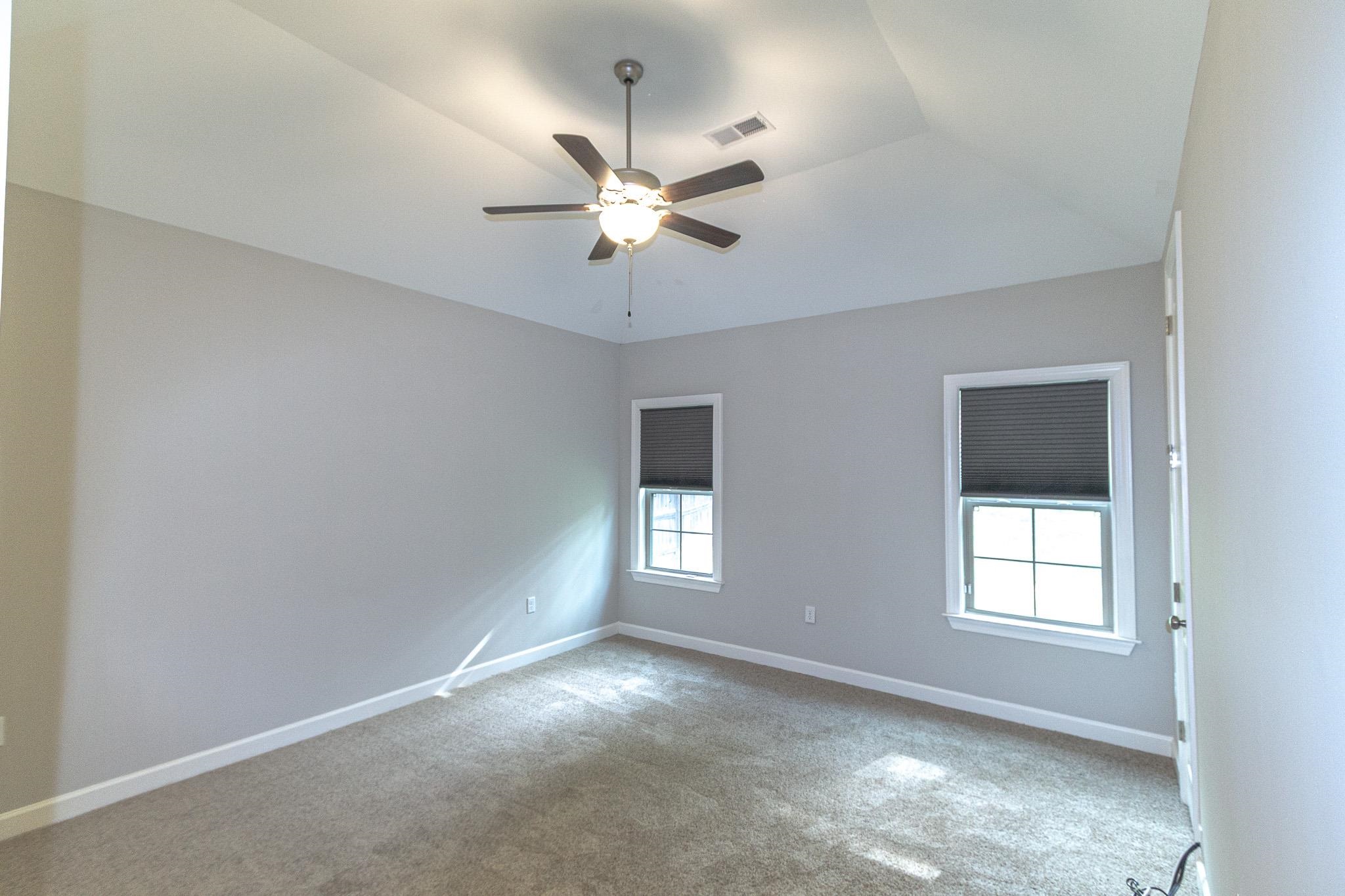 2422 Crimson Ridge Lane Cordova, TN 38016 - Photo 14 of 36 Empty room with ceiling fan, carpet flooring, and vaulted ceiling