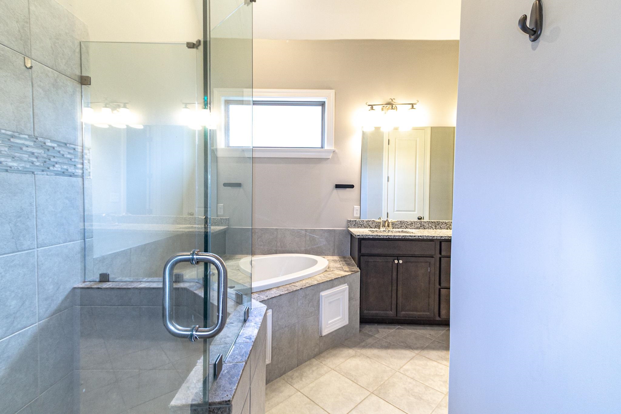 2422 Crimson Ridge Lane Cordova, TN 38016 - Photo 17 of 36 Full bath featuring a shower stall, vanity, a bath, and light tile patterned floors