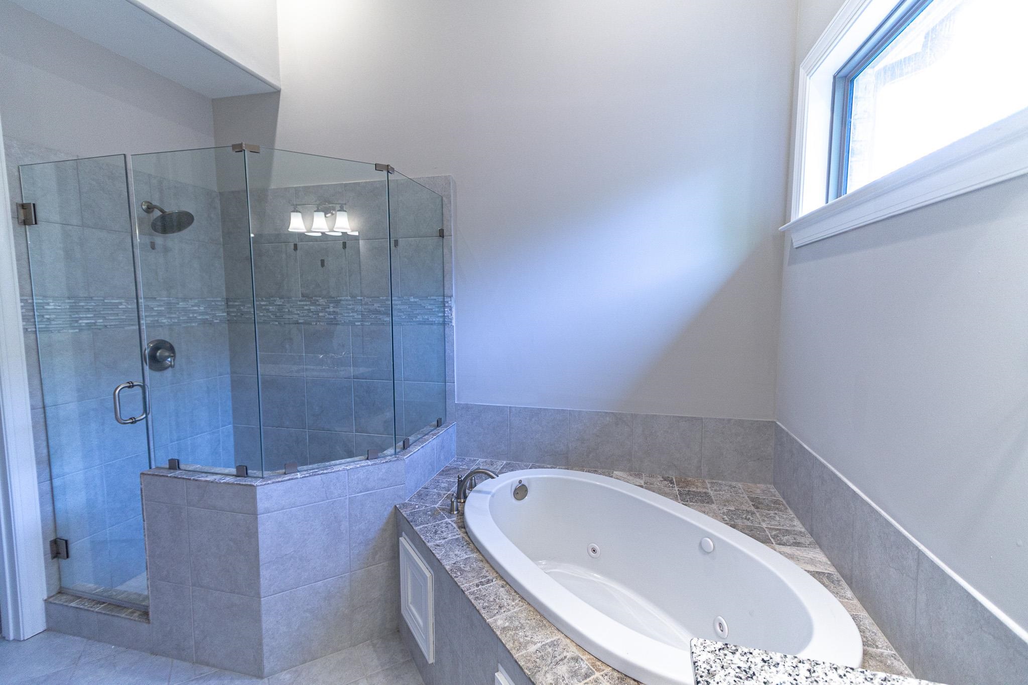 2422 Crimson Ridge Lane Cordova, TN 38016 - Photo 18 of 36 Bathroom featuring a stall shower and a whirlpool tub