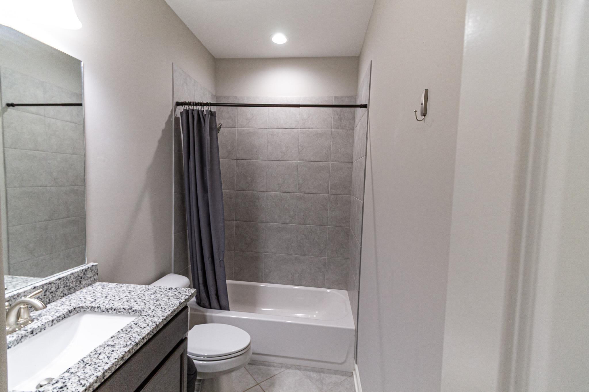 2422 Crimson Ridge Lane Cordova, TN 38016 - Photo 24 of 36 Bathroom featuring vanity, shower / bath combo, and light tile patterned floors
