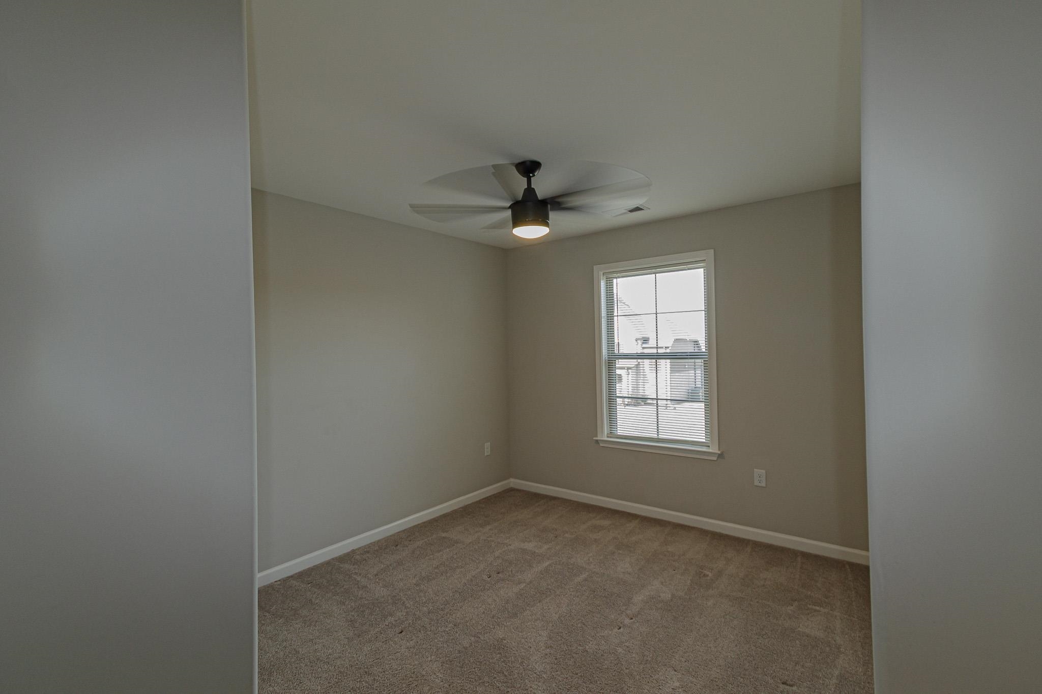 2422 Crimson Ridge Lane Cordova, TN 38016 - Photo 25 of 36 Unfurnished room featuring light colored carpet and ceiling fan