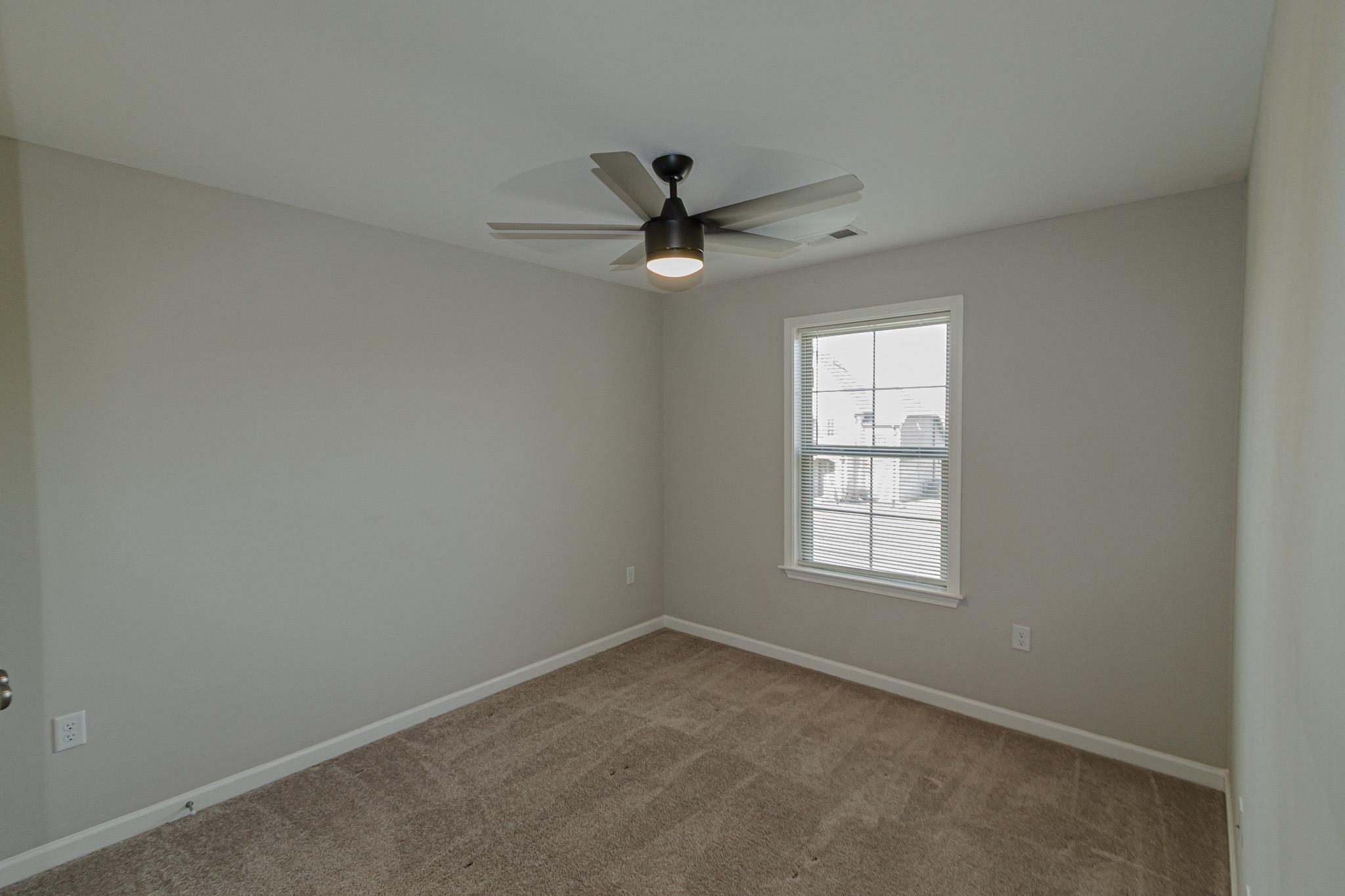 2422 Crimson Ridge Lane Cordova, TN 38016 - Photo 26 of 36 Carpeted spare room with baseboards and a ceiling fan