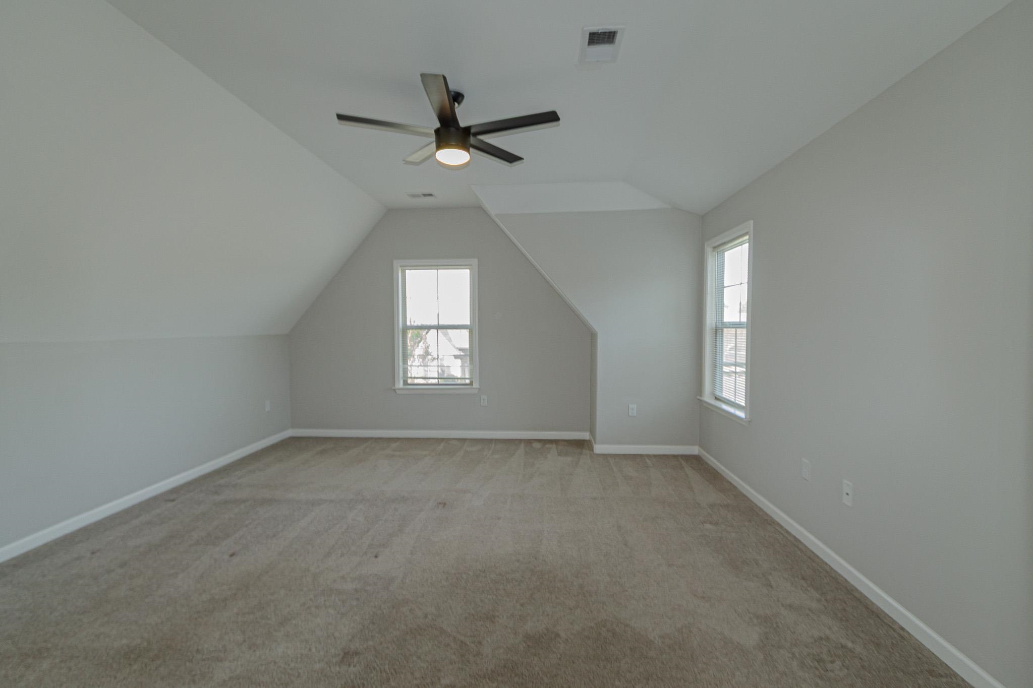2422 Crimson Ridge Lane Cordova, TN 38016 - Photo 29 of 36 Bonus room featuring vaulted ceiling, light colored carpet, and a ceiling fan