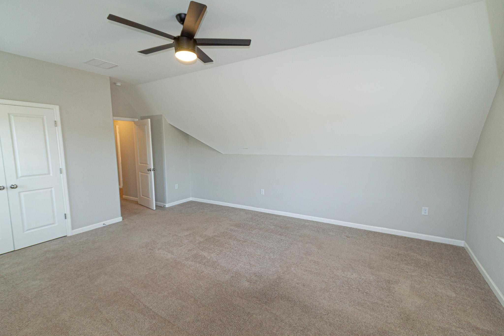 2422 Crimson Ridge Lane Cordova, TN 38016 - Photo 30 of 36 Additional living space featuring ceiling fan, lofted ceiling, and light colored carpet
