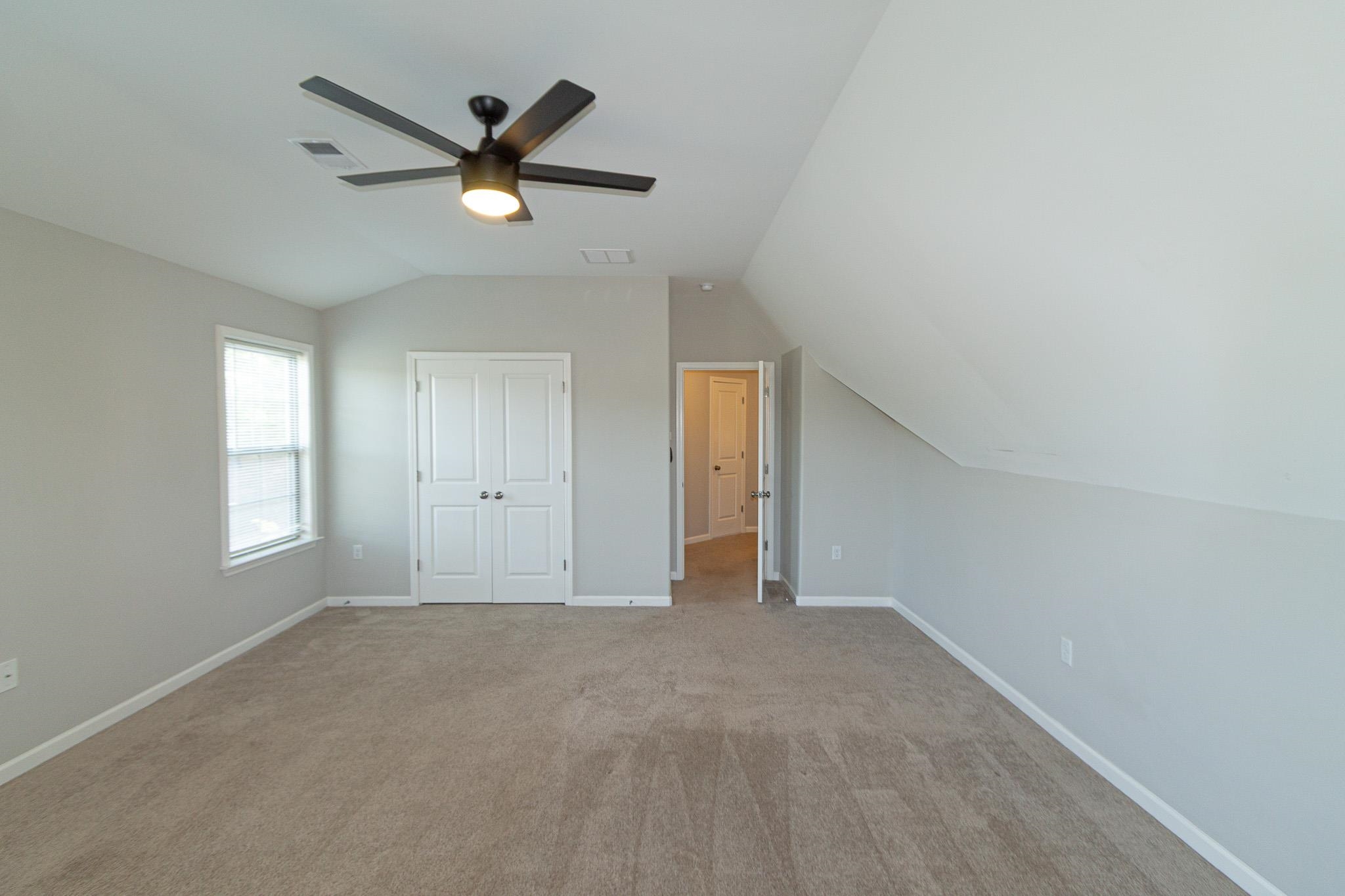 2422 Crimson Ridge Lane Cordova, TN 38016 - Photo 31 of 36 Unfurnished bedroom with vaulted ceiling, carpet flooring, a ceiling fan, and a closet
